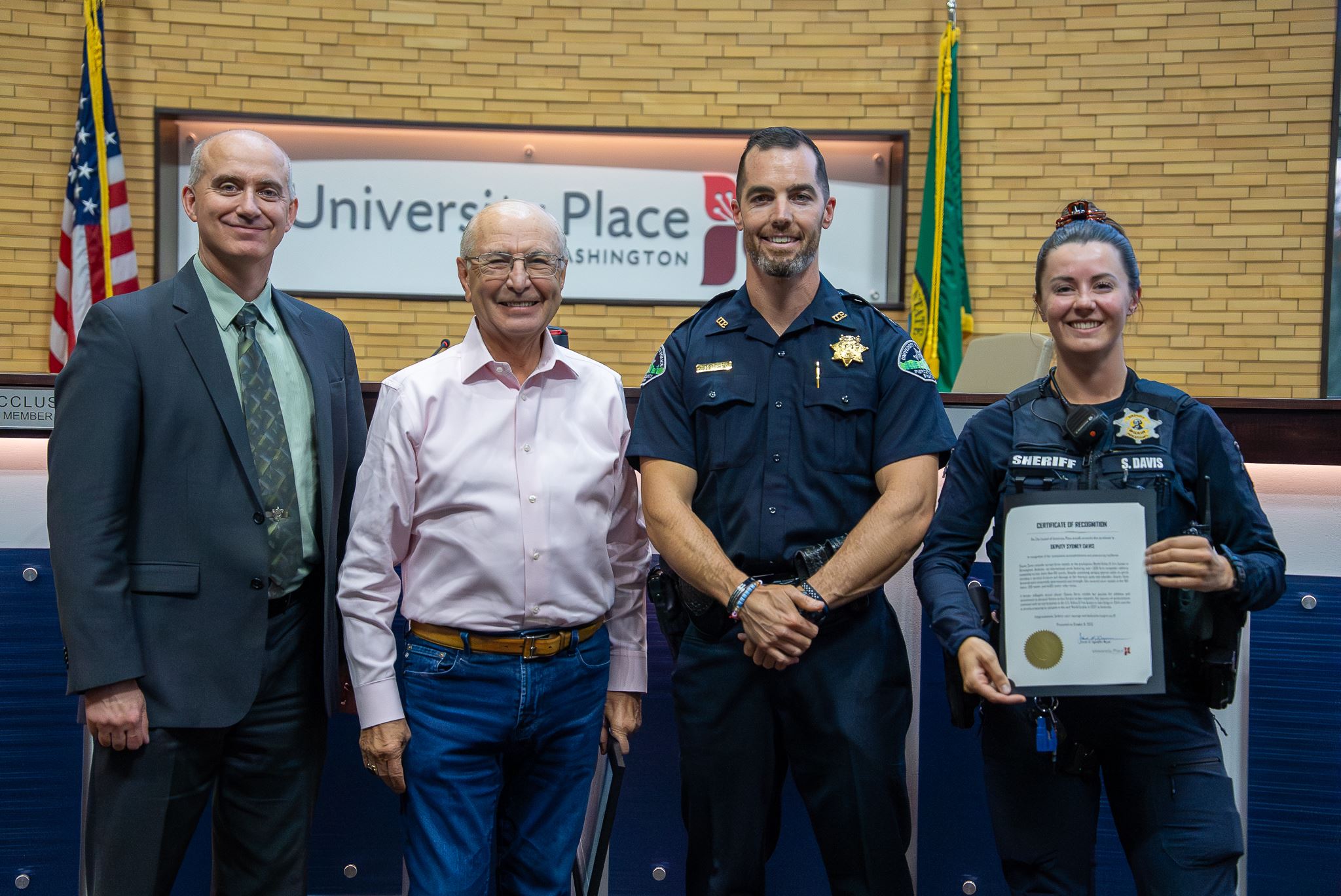 Group of people standing for a photo holding a certificate in Council Chambers