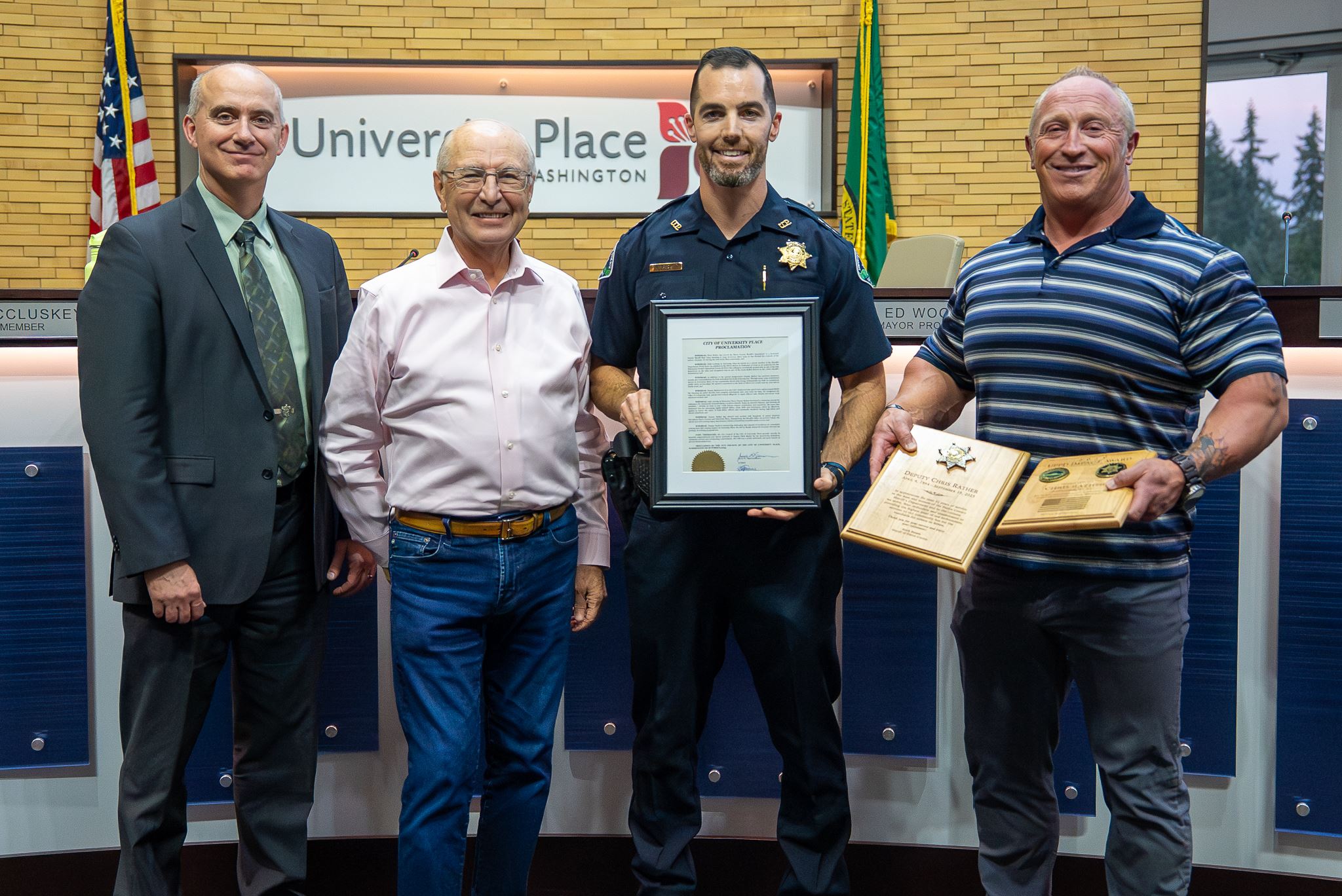 Group of people standing for a photo holding a certificate in Council Chambers