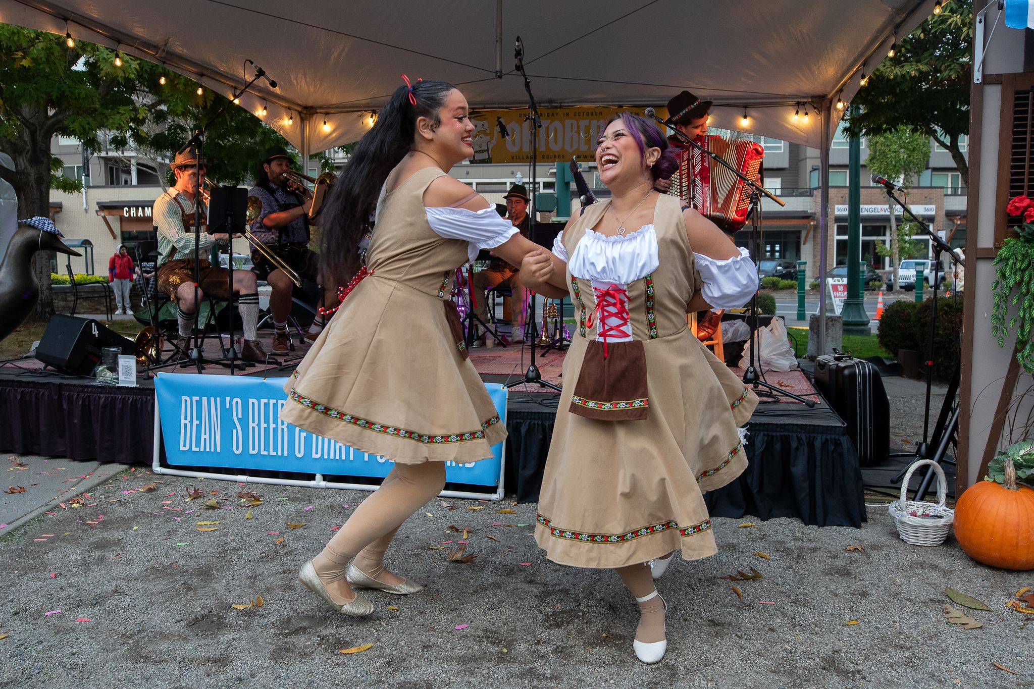 two women dancing in front of a stage